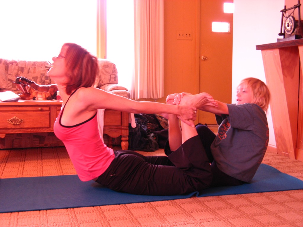 Here's my son Duncan prying me into a backbend pose in 2007, four years into yoga for me. The "full" version of this pose involves reaching overhead (not back) and holding one's feet. Sooo not happening. But then, I had a dream.